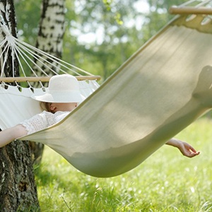 Woman asleep in a cozy outdoor hammock 